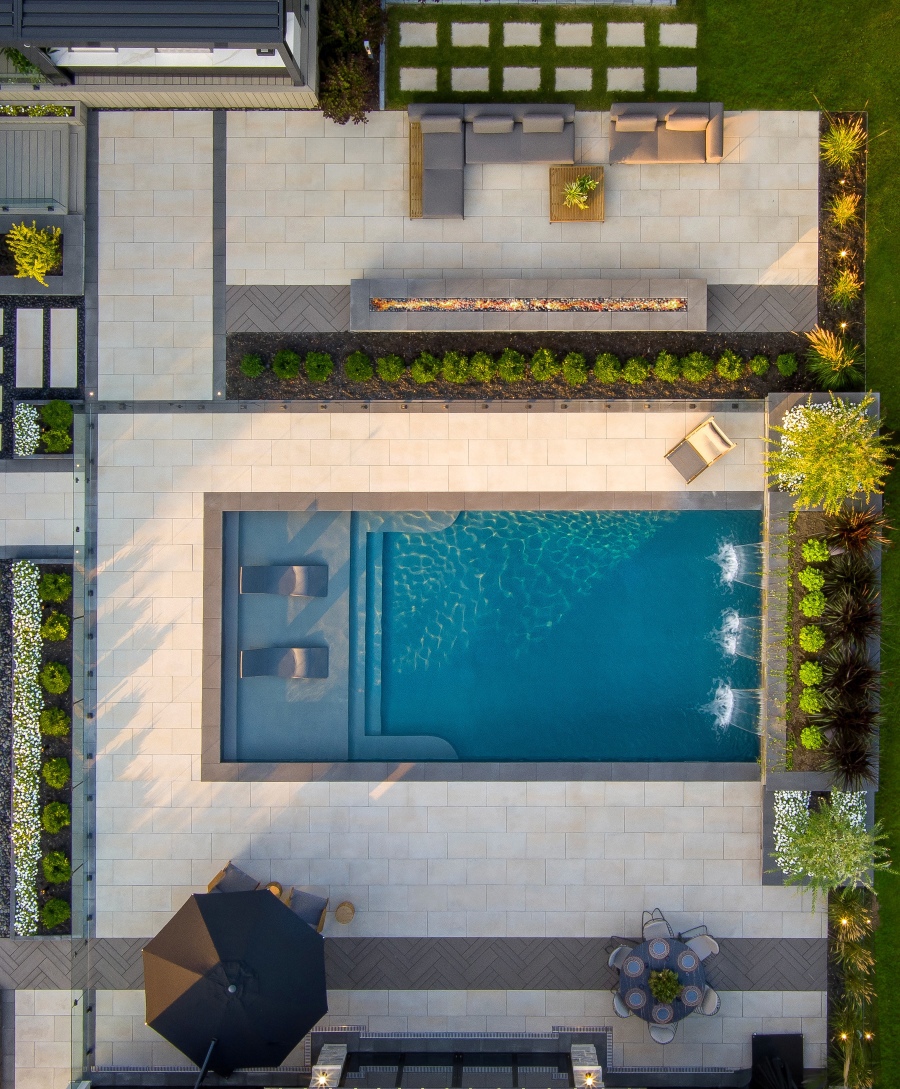 Aerial view of a backyard featuring Borealis Slabs in Riviera adding warmth with their wood-like texture.