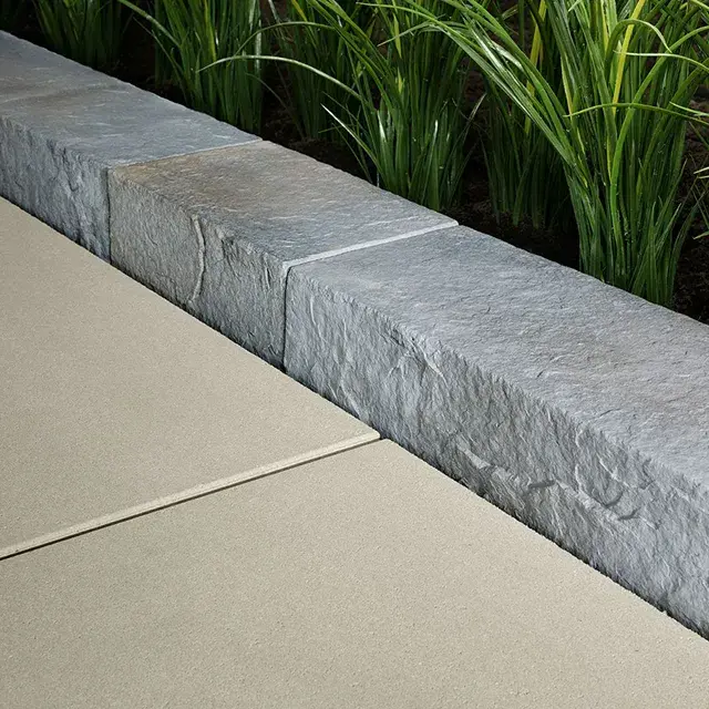 Rocka by Techo-Bloc, large natural stone imitation edging stones, perfect for creating structured borders around garden beds and walkways.