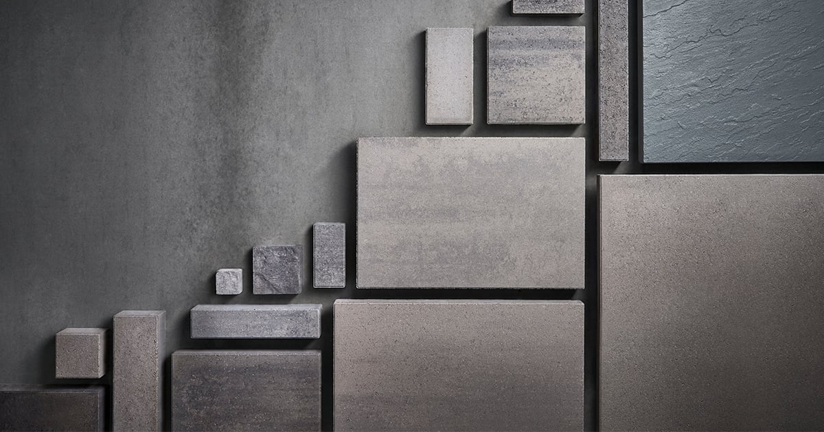 Display of slab samples arranged in various sizes against a dark wall—representing design tools available to professionals.