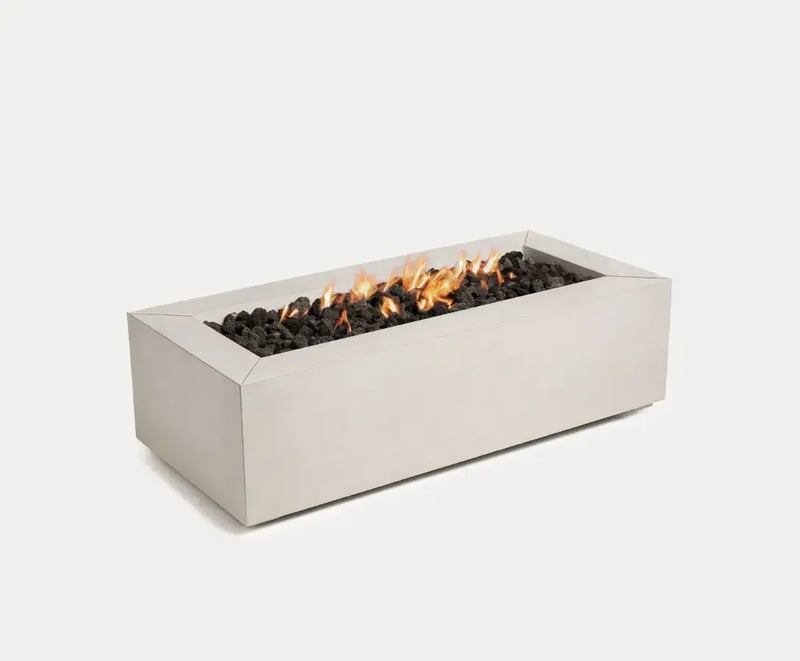 Sculptura Firepit Rectangle by Techo-Bloc featuring a contemporary concrete design, filled with black lava stones for a clean, minimalist aesthetic.
