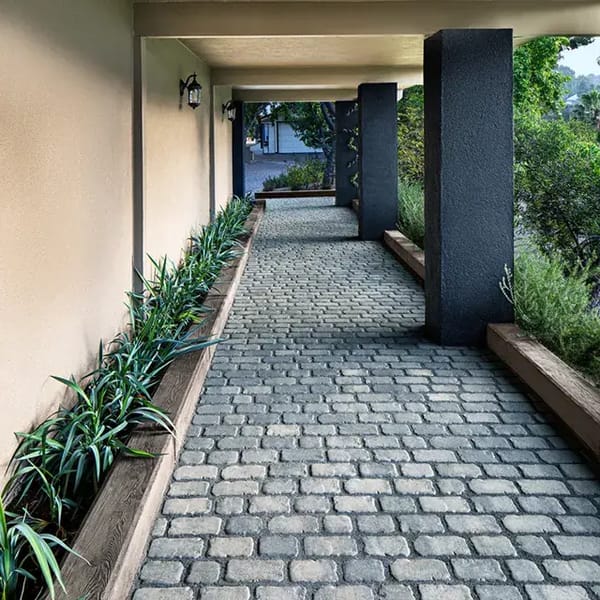Villagio Pavers by Techo-Bloc, rustic cobblestone pavers arranged in a permeable walkway, adding charm and functionality to the garden path.