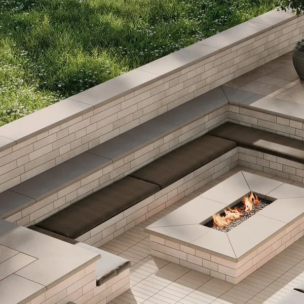 Sandstone Veneer Wall by Techo-Bloc, smooth stone veneer used for a modern outdoor wall and seating area, complementing the Sandstone Collection.