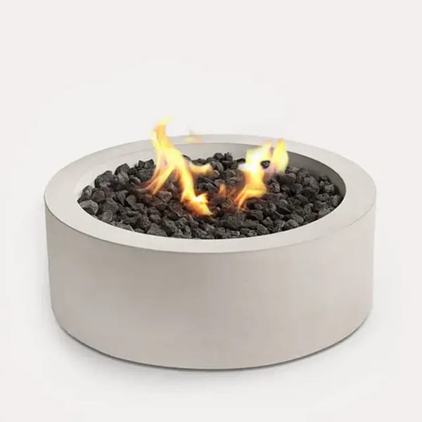 Sculptura Fire Pit Circle by Techo-Bloc, circular fire pit with lava rock, creating a stylish and cozy outdoor feature with a sleek modern design.