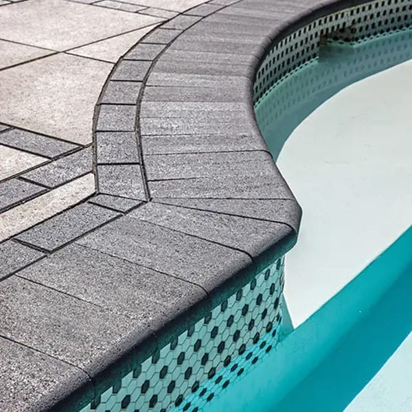 Bullnose by Techo-Bloc, traditional 12x5 concrete pool cap with rounded edges, providing a smooth, classic finish for pool coping and wall tops.