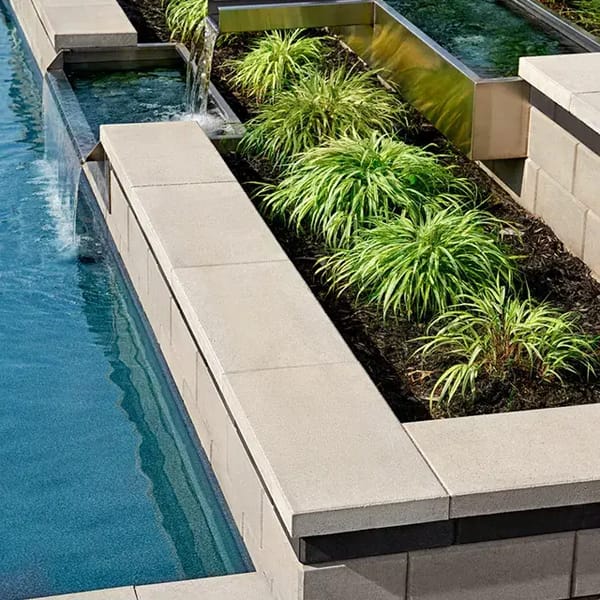 Raffinato Smooth by Techo-Bloc, modern concrete pool cap with sleek edges, providing a refined finish for pool coping and wall tops.