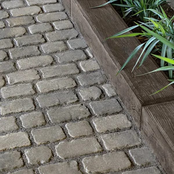 Borealis by Techo-Bloc, wood-like concrete edging stones inspired by railroad ties, perfect for bordering planters, mulch, and garden beds.