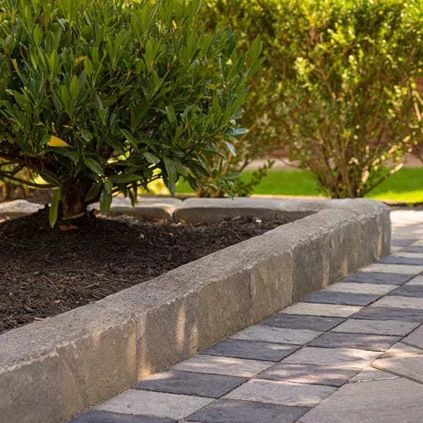 Avignon by Techo-Bloc, slate-textured landscape edging stones, perfect for creating clean, natural borders around garden beds and mulch areas.