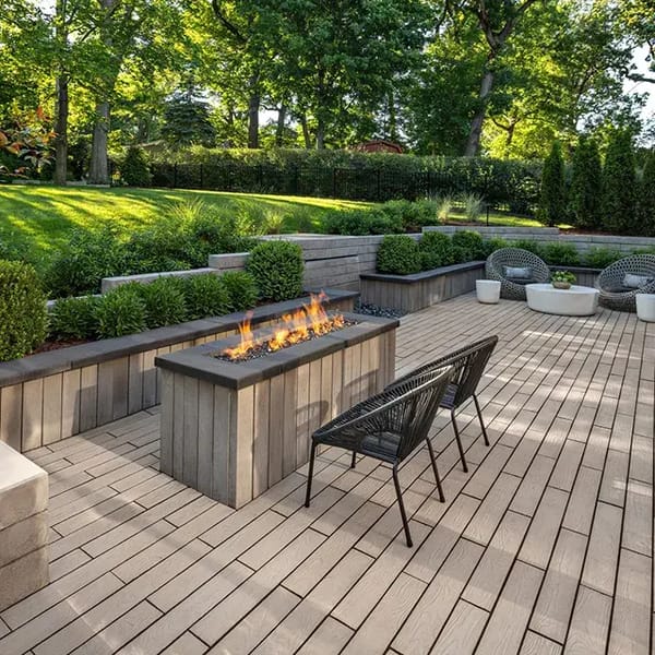 A sleek, modern patio featuring wood-look texture with subtle patterns, using Borealis Slabs by Techo-Bloc, blending with natural surroundings.