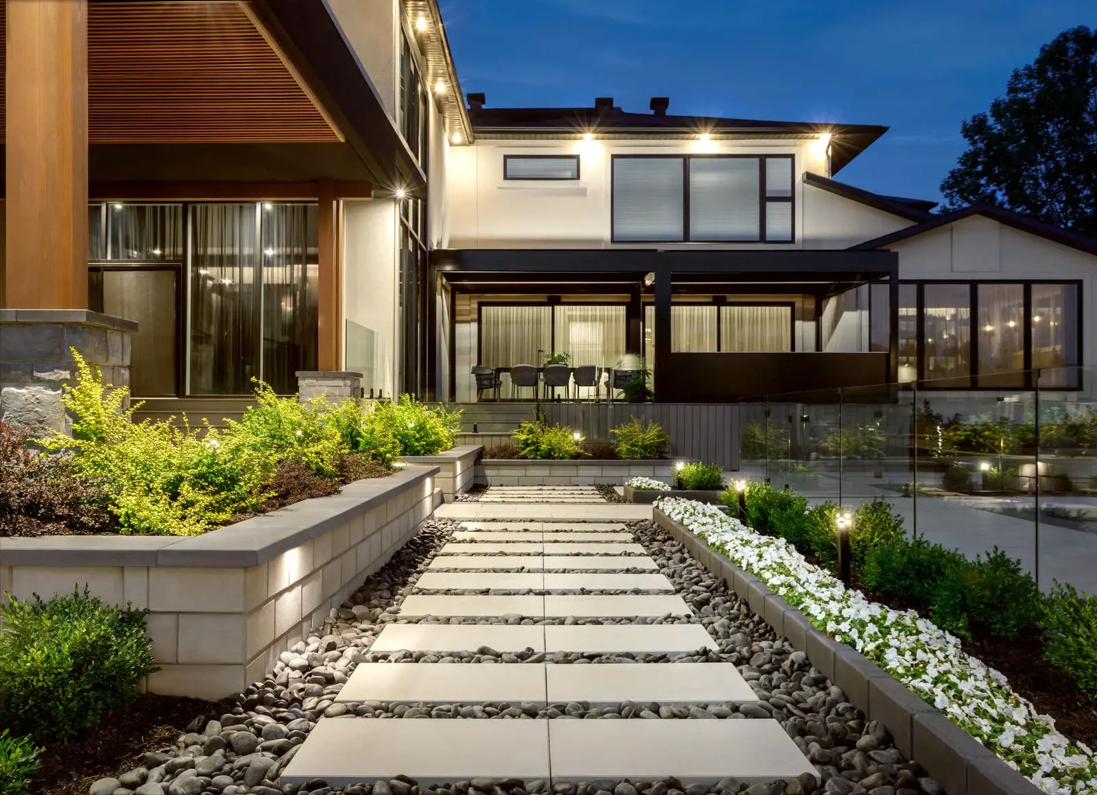 Garden pathway featuring planter walls built with Raffinato Walls in Beige Cream for clean architectural structure.